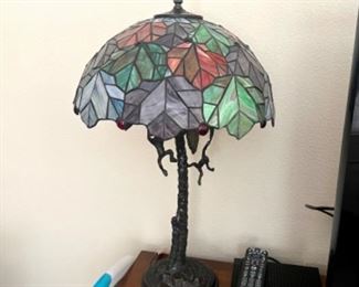 Adorable, Tiffany-style lamp with monkeys hanging from it.