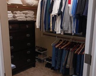 Full walk-in closet men's clothing.