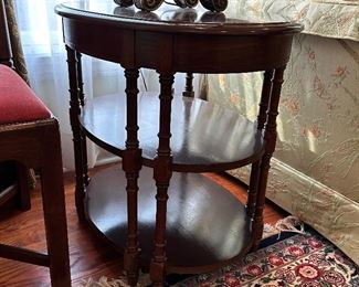 One of a pair of oval tiered tables 