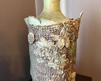 Lot 009-DR: Artisan Large Ceramic Vase

Features: 
•	Hefty, green, textural ceramic vase signed, “Mimi Shimmin 1992”

Dimensions: 17”H x 9”D (at widest)

Condition: Very Good pre-owned condition
