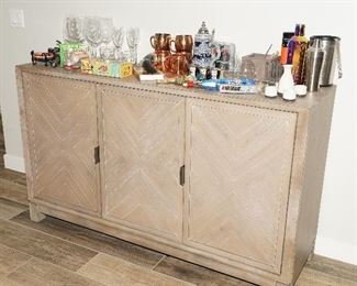 Bar cabinet with many fun bar accessories and beer tap handles from Schlitz, Miller, & more