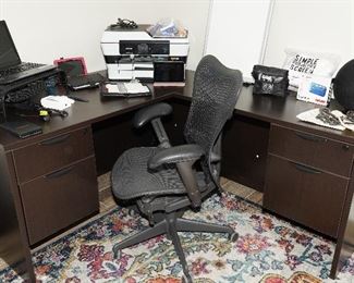 Modular L shaped computer desk with Herman Miller rolling office chair, Harmon Kardon portable speaker, apple ipods, kindles and more.
