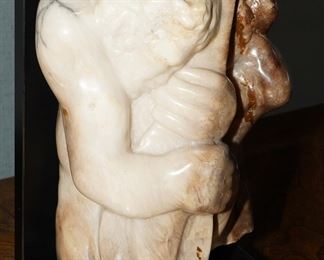 Marble stone sculpture of a man holding a mandolin-artist unknown.