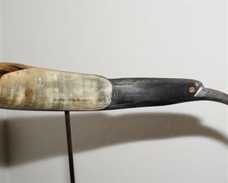 Carved toucan horn sculpture