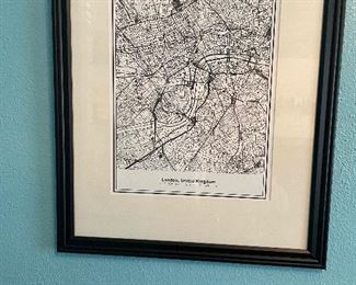Maps from places the owner has visited are displayed in this home office