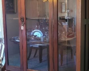 Antique wardrobe converted to curio cabinet. The wood panels are available to restore to wardrobe.