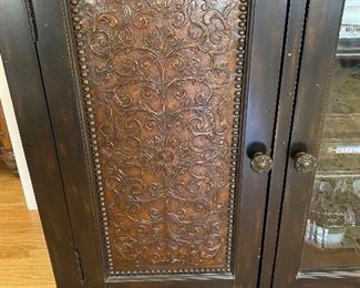Hooker Furniture Distressed Media Cabinet - 59” wide x 23” deep x 36” high.  Two decorative doors with enclosed storage.  Middle door is glass.  Has vents and cutouts for wiring.  Black distressed with brown tones running thru it.  