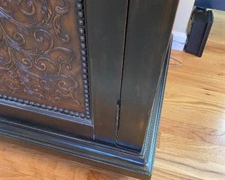 Hooker Furniture Distressed Media Cabinet - 59” wide x 23” deep x 36” high.  Two decorative doors with enclosed storage.  Middle door is glass.  Has vents and cutouts for wiring.  Black distressed with brown tones running thru it.  