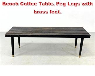 Lot 369 Modernist Ebonized Slat Bench Coffee Table. Peg Legs with brass feet.