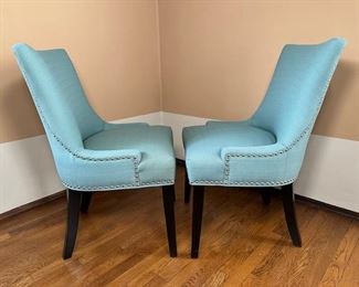 $200/pair (6 pairs available/ 12 chairs), Blue suede chairs with pinhead accents. 