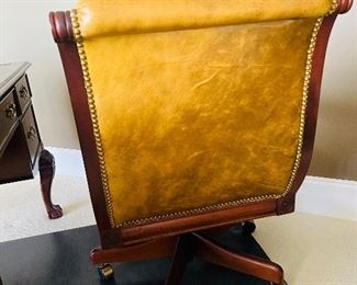 Leather with nail head trim and carved wood office chair on casters