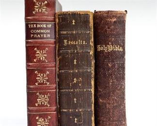 Three 18th and 19th century religious books.  Includes "The Book of Common Prayer" 1717 with engraved images; "The Raccolta; or, Collection of Indulgenced Prayers" 1867; and the "Holy Bible, Containing the Old and New Testament" c. 1870s.  Leatherbound, 24mo to 16mo (up to 6" high).  Some wear and losses, pages with toning and foxing.  ESTIMATE $40-60