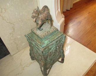 Figural lid on heavy metal footed urn.