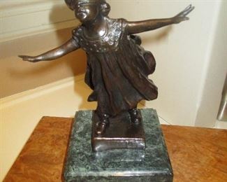 Bronze girl playing.  Blindfolded.