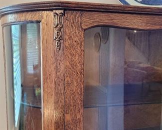 close-up detail of bow glass front china cabinet
