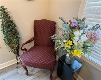 maroon arm chair, lighted topiary, large floral arrangement