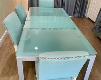 Modern glass and metal expandable dining room table. 77" x 35" x 30" (leaf is 24")