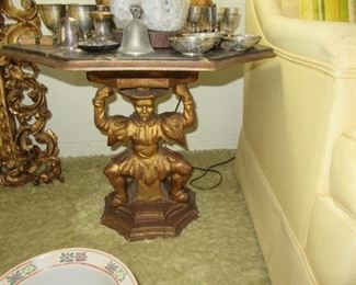 Pawley guilded table with man holdingup table