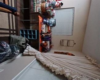 Halloween  party favors, ruffled  curtains,  sleeping bags, and air mattress. 