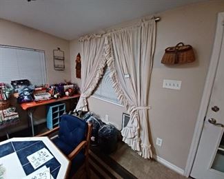 Halloween  party favors, ruffled  curtains, sleeping bags and air mattress, and rattan  fishing creel.