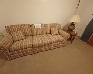Plaid covered sofa with arm sleeves and throw pillows
$75.00