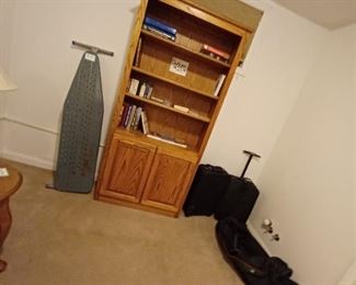 Bookcase, ironing board, & suitcases