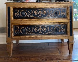 Britt Carter Reproduction Ebonzied Wood Commode With Gilt Trim. Measures 42.5" W x 20.5" D x 34" H.