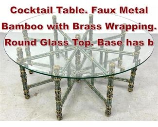 Lot 632 Designer 8 Legged Cocktail Table. Faux Metal Bamboo with Brass Wrapping. Round Glass Top. Base has b