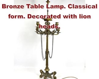 Lot 782 French Empire Bronze Table Lamp. Classical form. Decorated with lion heads. 