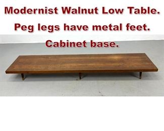 Lot 885 79 Long Low Modernist Walnut Low Table. Peg legs have metal feet. Cabinet base. 