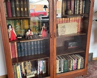 antique oak bookcase with glass doors/ book collections Charles dickens and more vintage japanese dolls and accessories giant vintage postcard