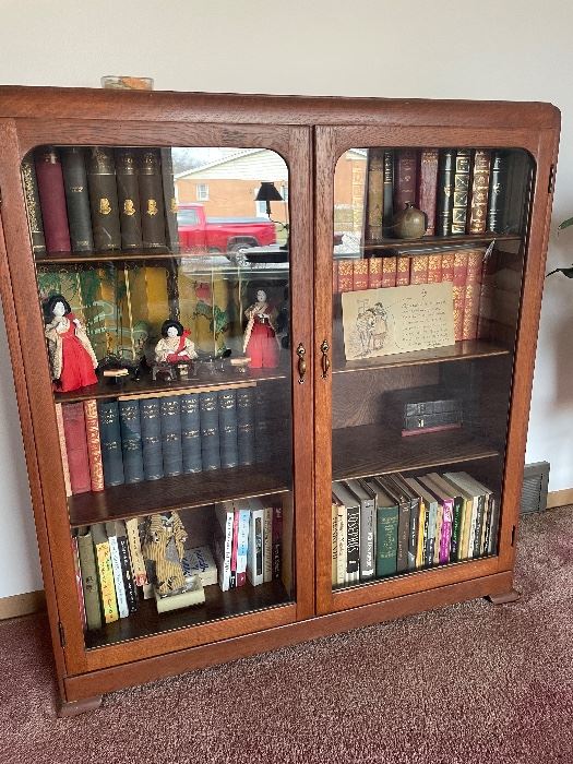 antique oak bookcase with glass doors/ book collections Charles dickens and more vintage japanese dolls and accessories giant vintage postcard
