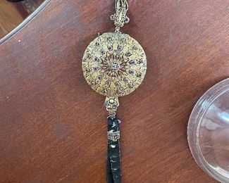 Antique compact purse, unusual. gold filigree design with stones and black velvet back. 
