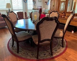 round fold-out expandable dining table with six chairs