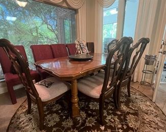dining table and two sets of dining chairs