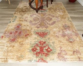 Multi-colored tan/red wool floor rug-5 x 8 approximately