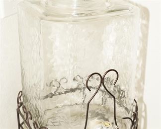 Glass beverage dispenser on iron scroll stand