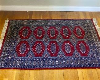 Hand-knotted wool area rug.