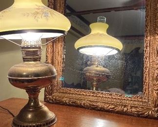 Gilded mirror and brass hurricane lamp