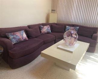 Carter Purple Curved Sectional Sofa, Vintage Lacquer Tiered Pedestal Coffee / Cocktail Table, Peter Bramhall Glass Orb Sculpture