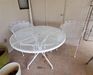 White wrought iron patio set
Table-41 inches round & 29 inches high
Chairs-31 inches high