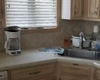 Kitchen has a corner sink