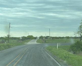 Keep going straight onto the light colored paved  road, house will be on left watch for Estate Sale Signs