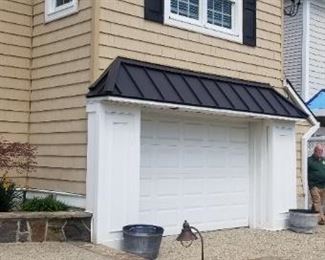 Siding; 10' x 6 1/2' garage door with electric opener