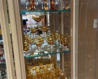 Amber plates, cups & saucers, glassware and candle holders. 