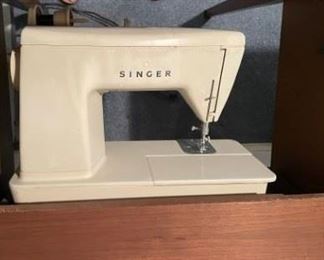 Singer sewing machine in cabinet. 
