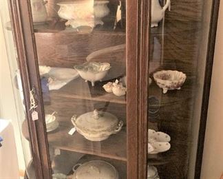 One of two antique curved front display cabinets