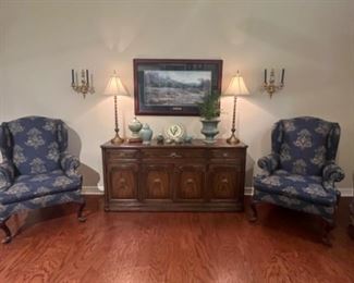 Two. Matching wing back chairs and buffet storage.