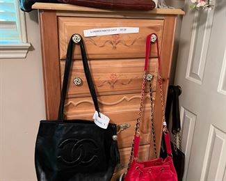 Chanel purses. Coach purses. Pretty tall chest.