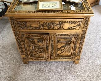 Carved Asian small cabinet with glass top